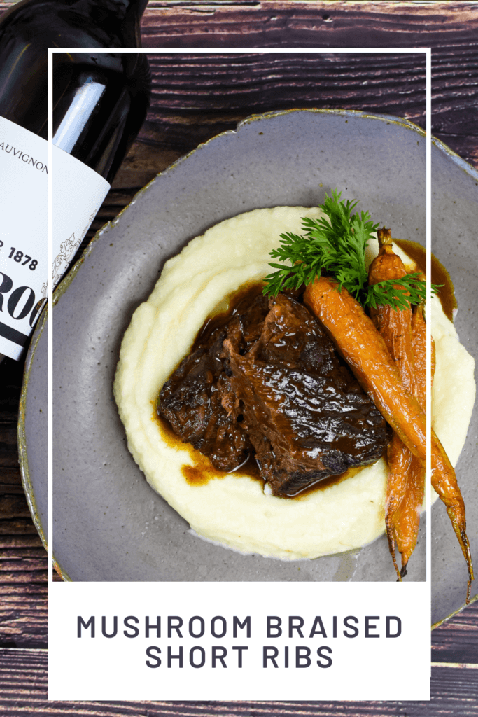 seabrook cabernet sauvignon, braised short ribs, cauliflower puree & carrots on a plate