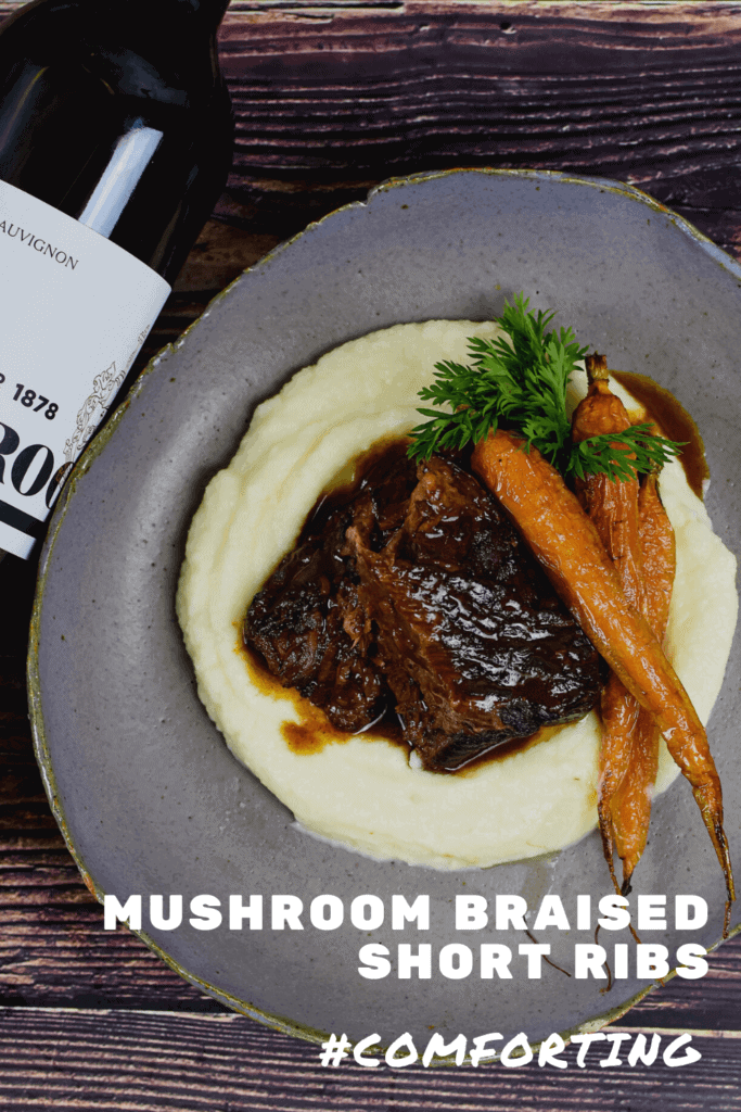 seabrook cabernet sauvignon, braised short ribs, cauliflower puree & carrots on a plate