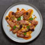 beautiful kingfish crudo on a CB2 plate