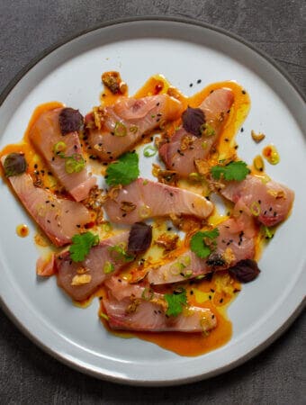 beautiful kingfish crudo on a CB2 plate