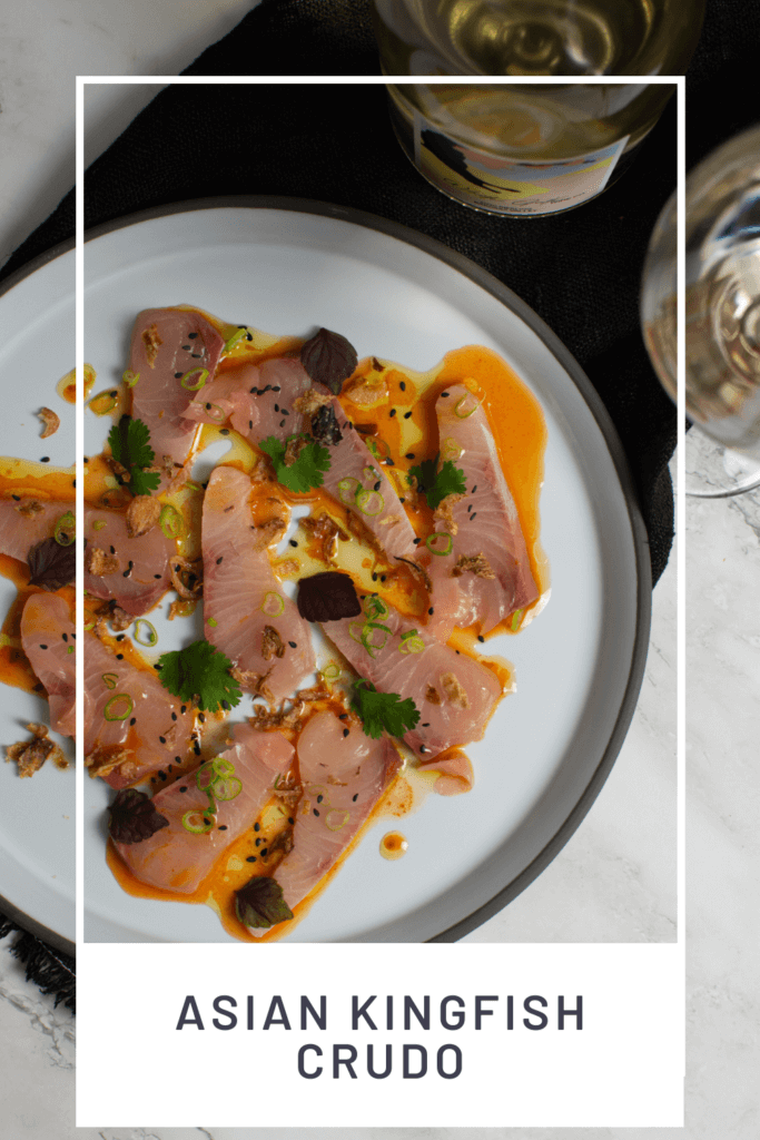 beautiful kingfish crudo on a CB2 plate, black napking and white gate wine co riesling