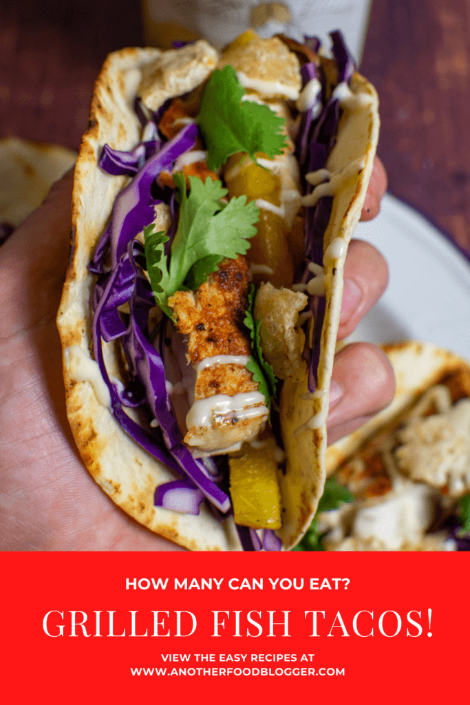 someone holding a grilled fish taco