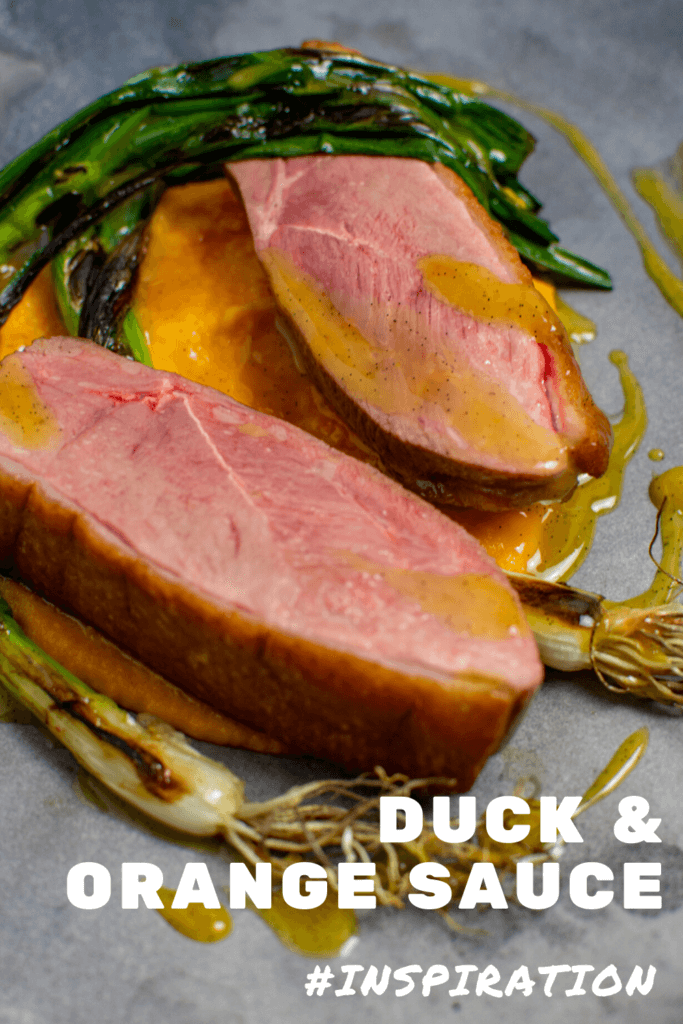 perfectly cooked duck breast, carrot puree & orange sauce on a made of australia plate