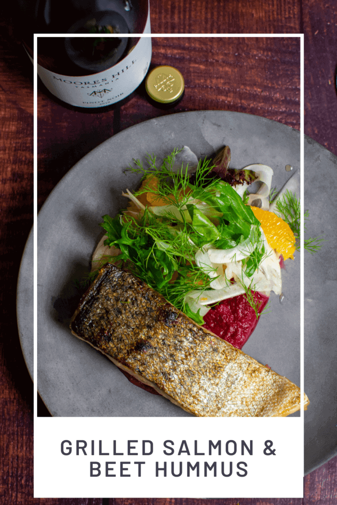 grilled salmon, beetroot hummus & fennel salad on a made of australia plate and a moores hill pinot noir