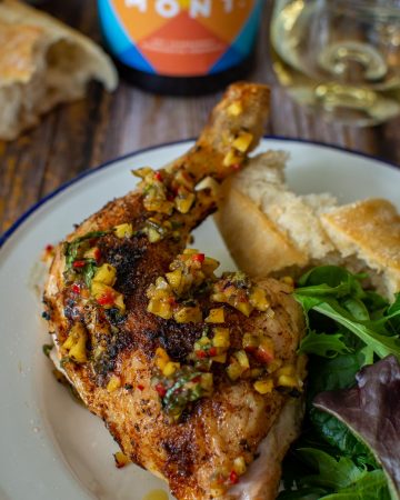 Mont wines, bbq spatchcock chicken & bread on a picnic table