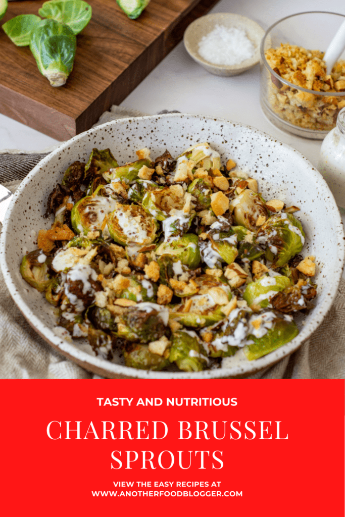 charred brussel sprouts & pangrattato in a bowl with a chopping board, brussel sprouts in the background