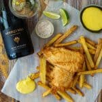 battered fish & chips, aioli, moores hill blanc de blanc wine & salt on a wooden table