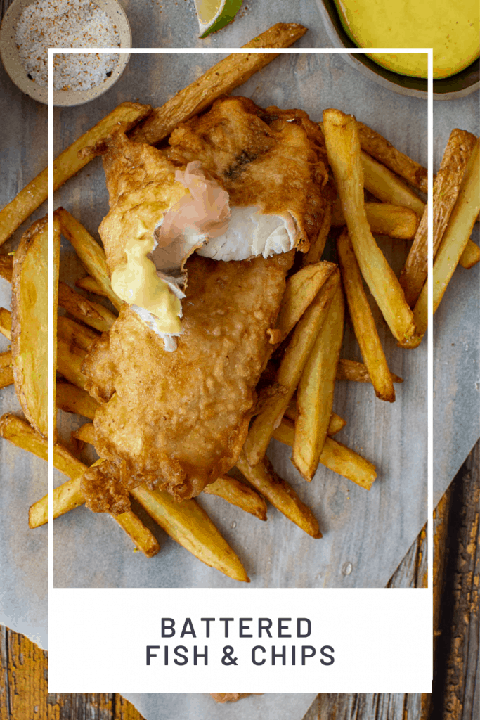 battered fish & chips & pickled ginger on a wooden table