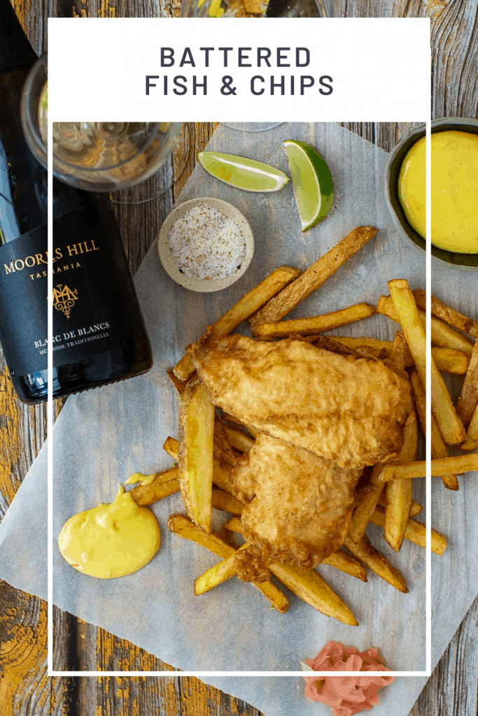 battered fish & chips, aioli, moores hill blanc de blanc wine & salt on a wooden table