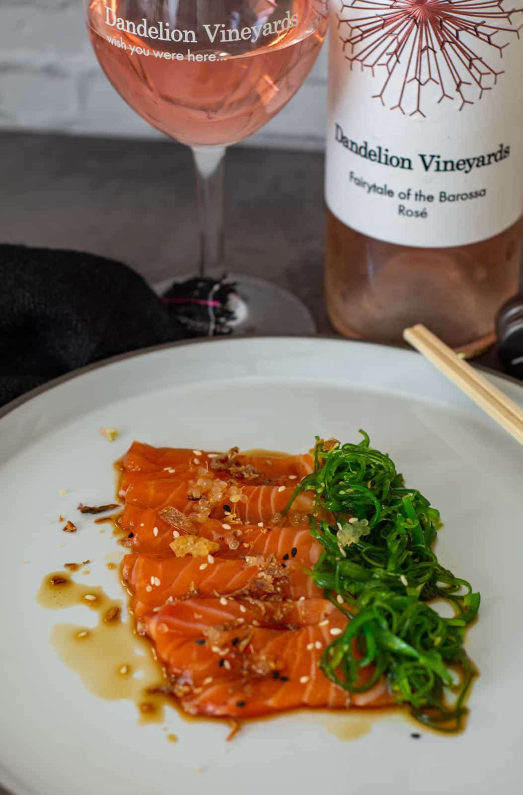 salmon crudo w/ ponzu sauce & wakame salad. Dandelion rose in background.