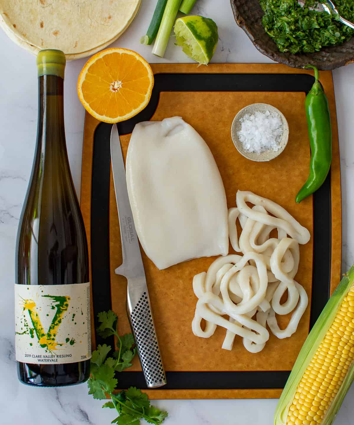 vanguardist riesling, calamari tubes & fruit/veg on a chopping board