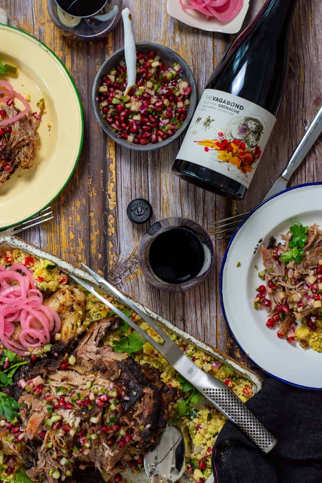 platter of slow cooked moroccan lamb, plates with food and bottle of thistledown vagabond grenache