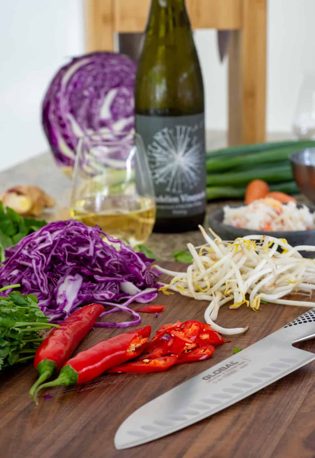 vegetables on a global chopping board with global chef knife on kitchen counter top