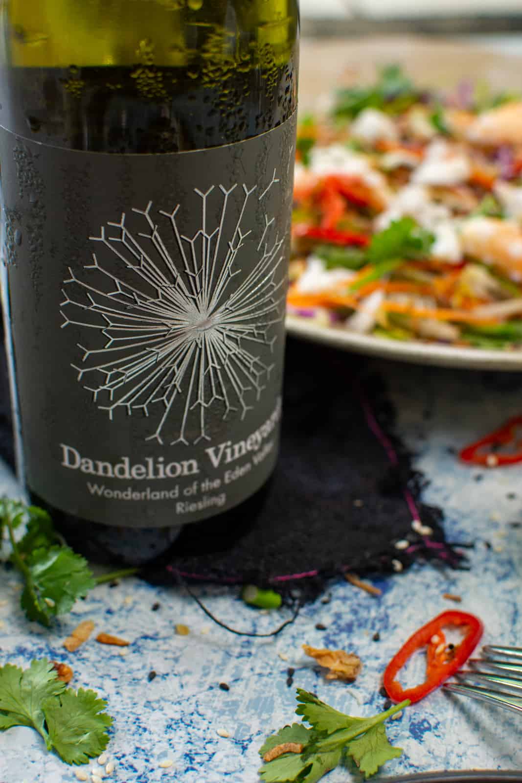 close up of dandelion riesling with spicy crab salad in background