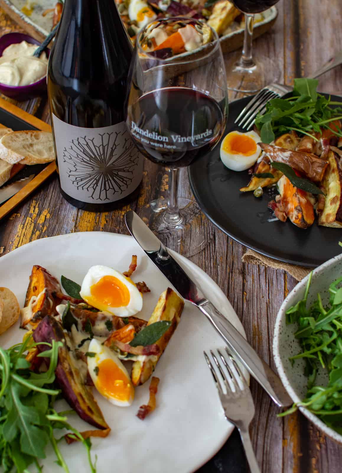 Dandelion vineyard wine and crispy roasted sweet potato salad on a plate