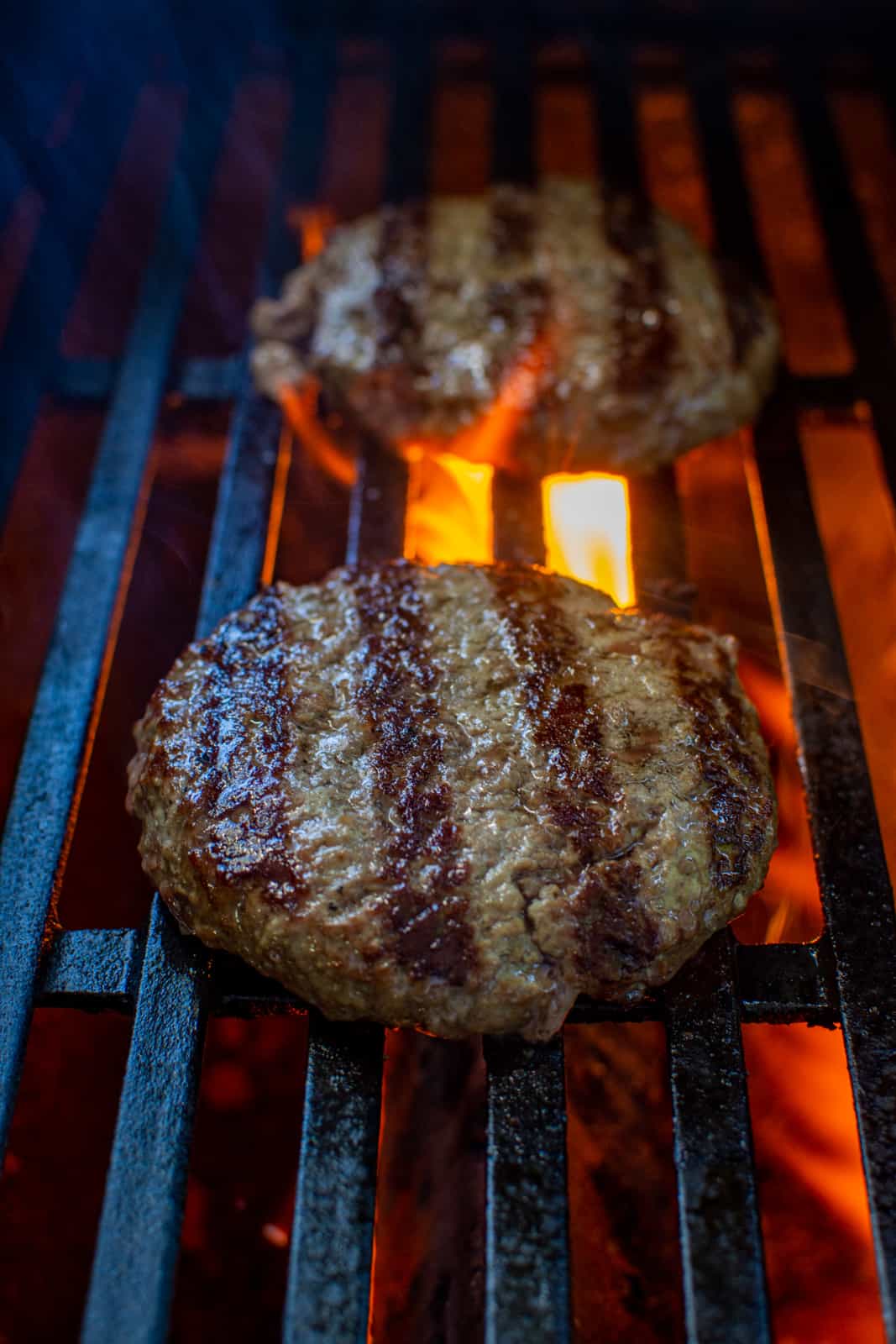 beef burgers grilling on a BBQ
