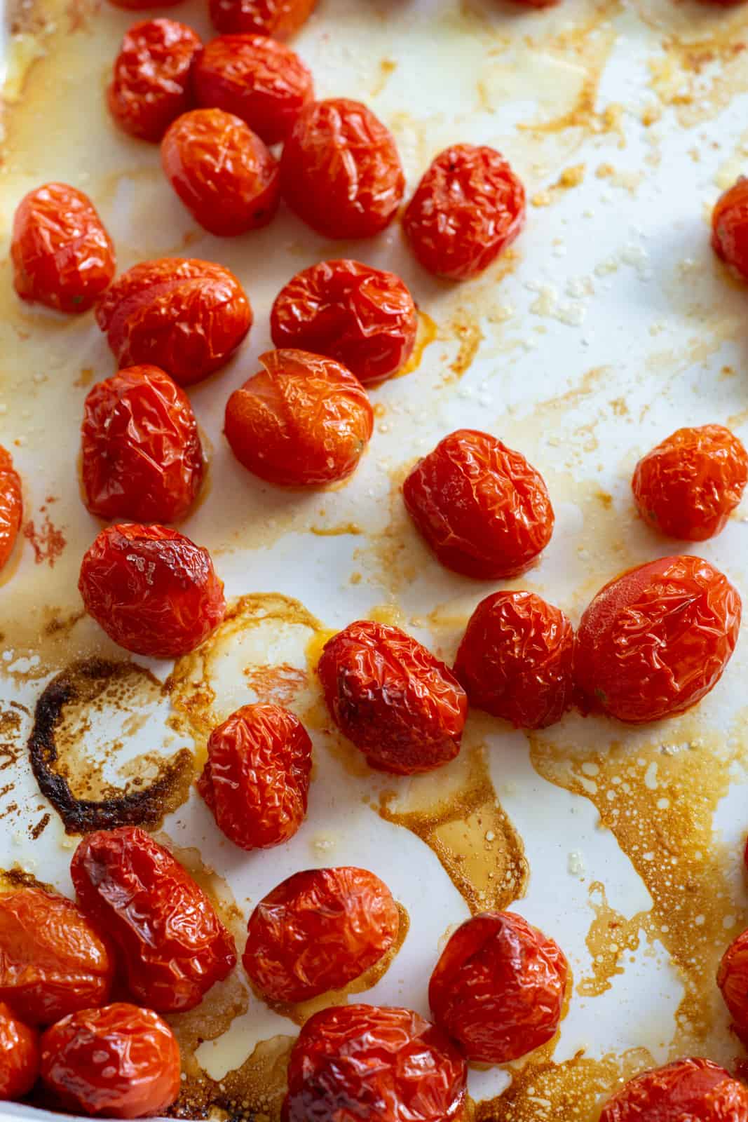 roasted cherry tomatoes on a baking tray for the tomato stock