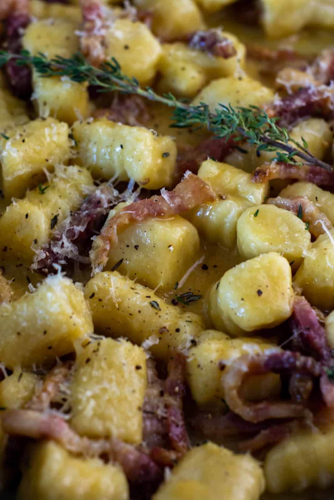 close up of gnocchi carbonara in frying pan