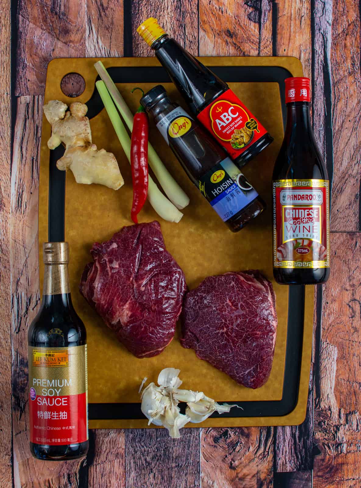 ingredients for slow cooked beef cheeks on a wooden chopping board