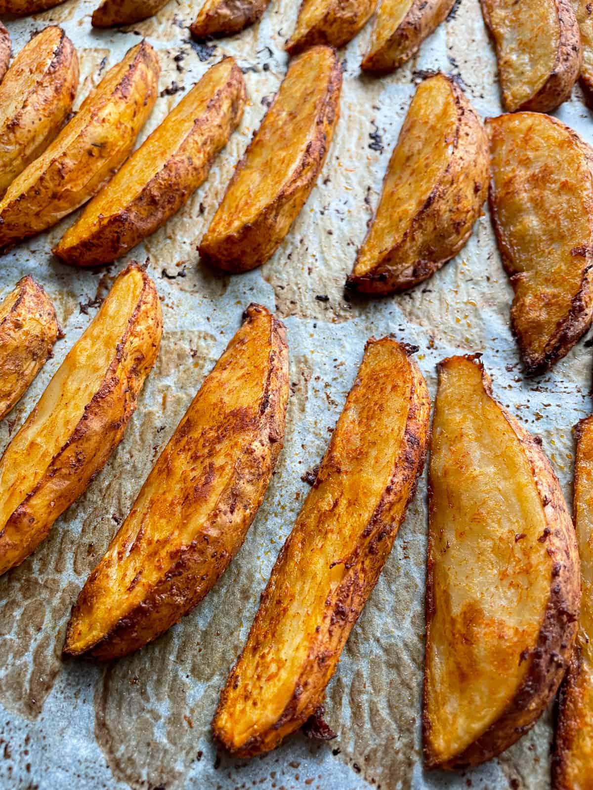spicy potato wedges on a tray 