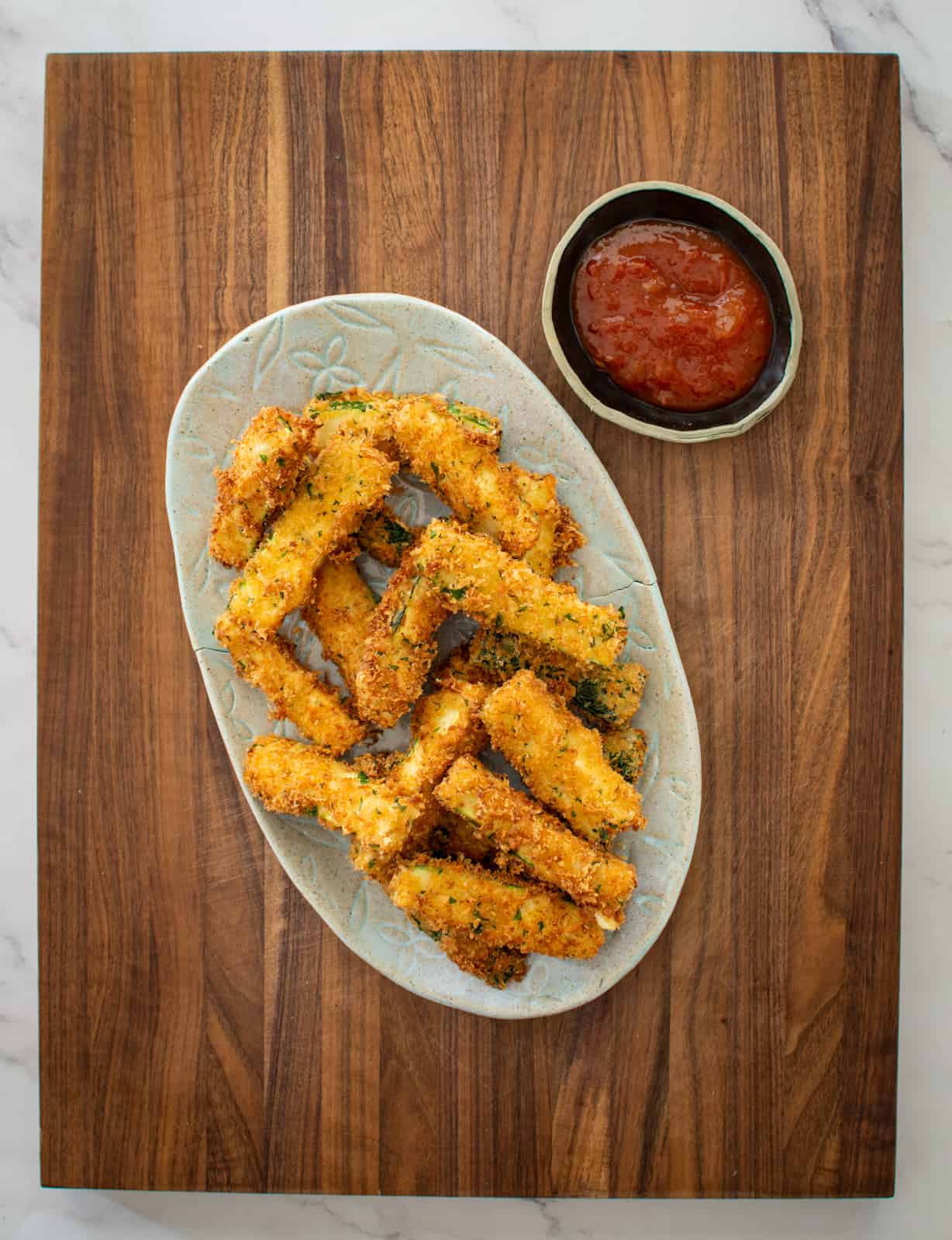cooked zucchini chips on a plate