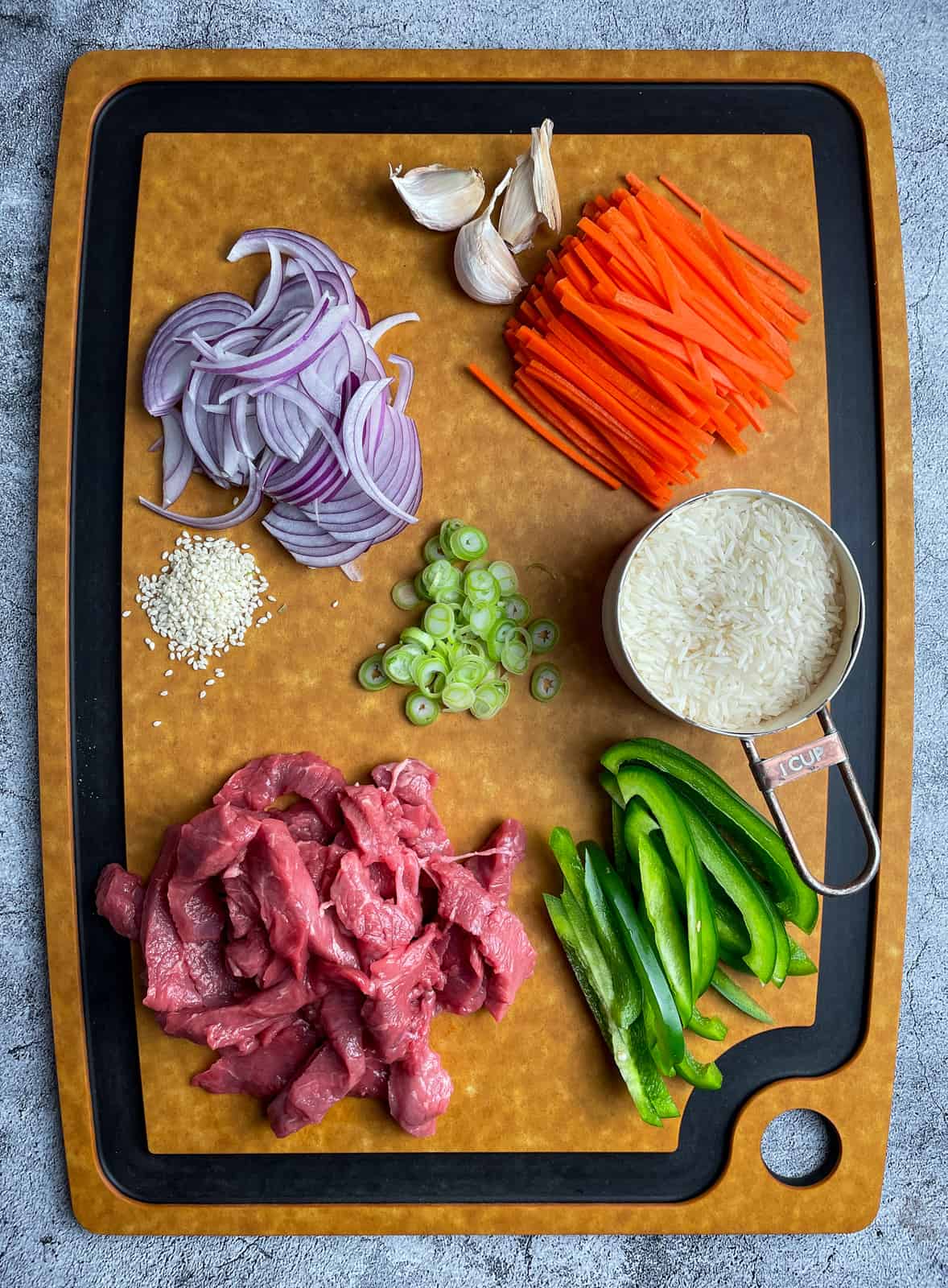 Chopped vegetables and beef on a chopping board