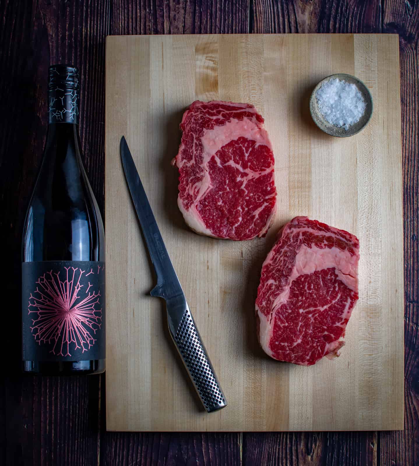 steak, red wine and a chef knife