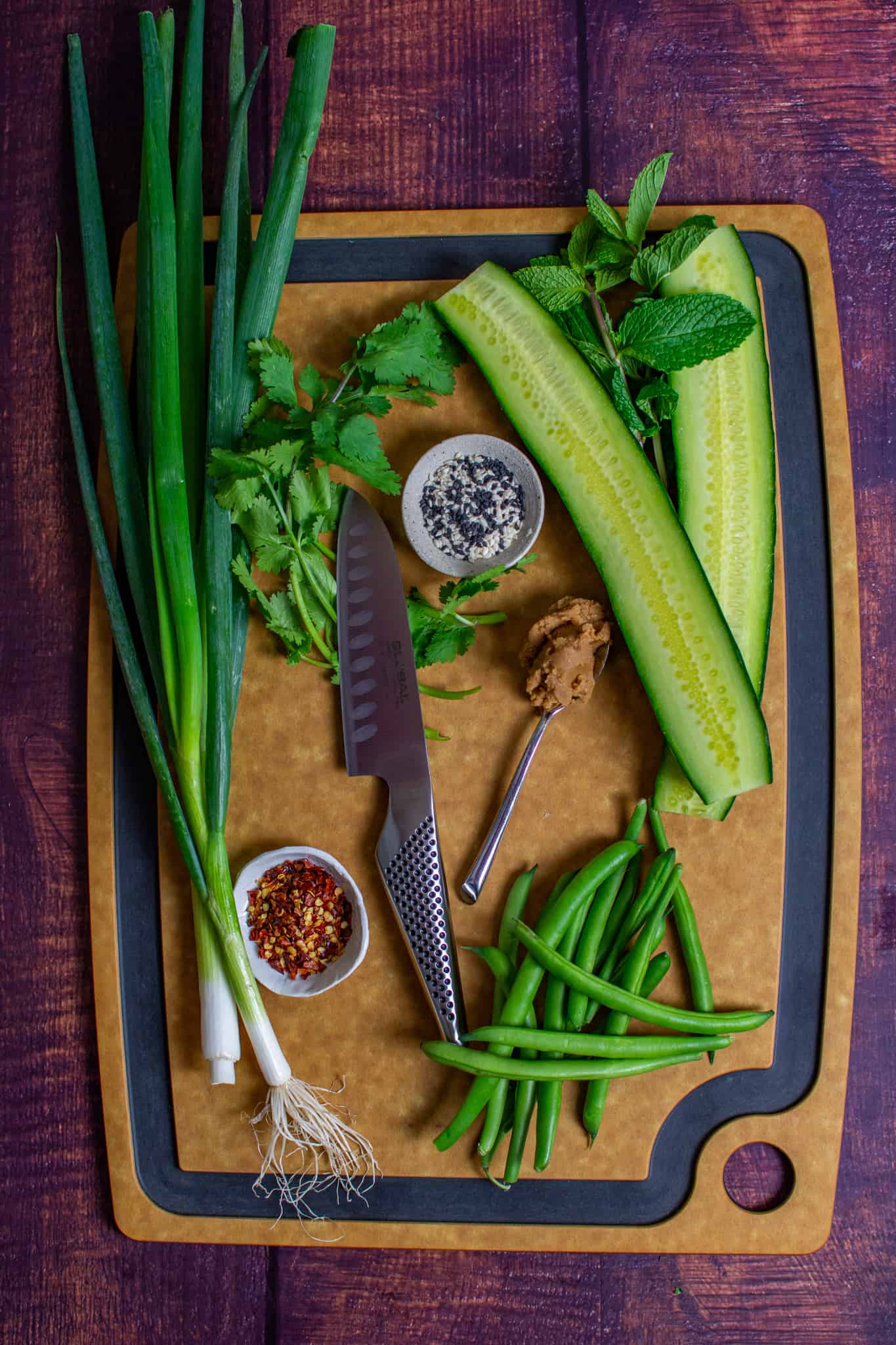 smashed cucumber salad ingredients on chopping board 