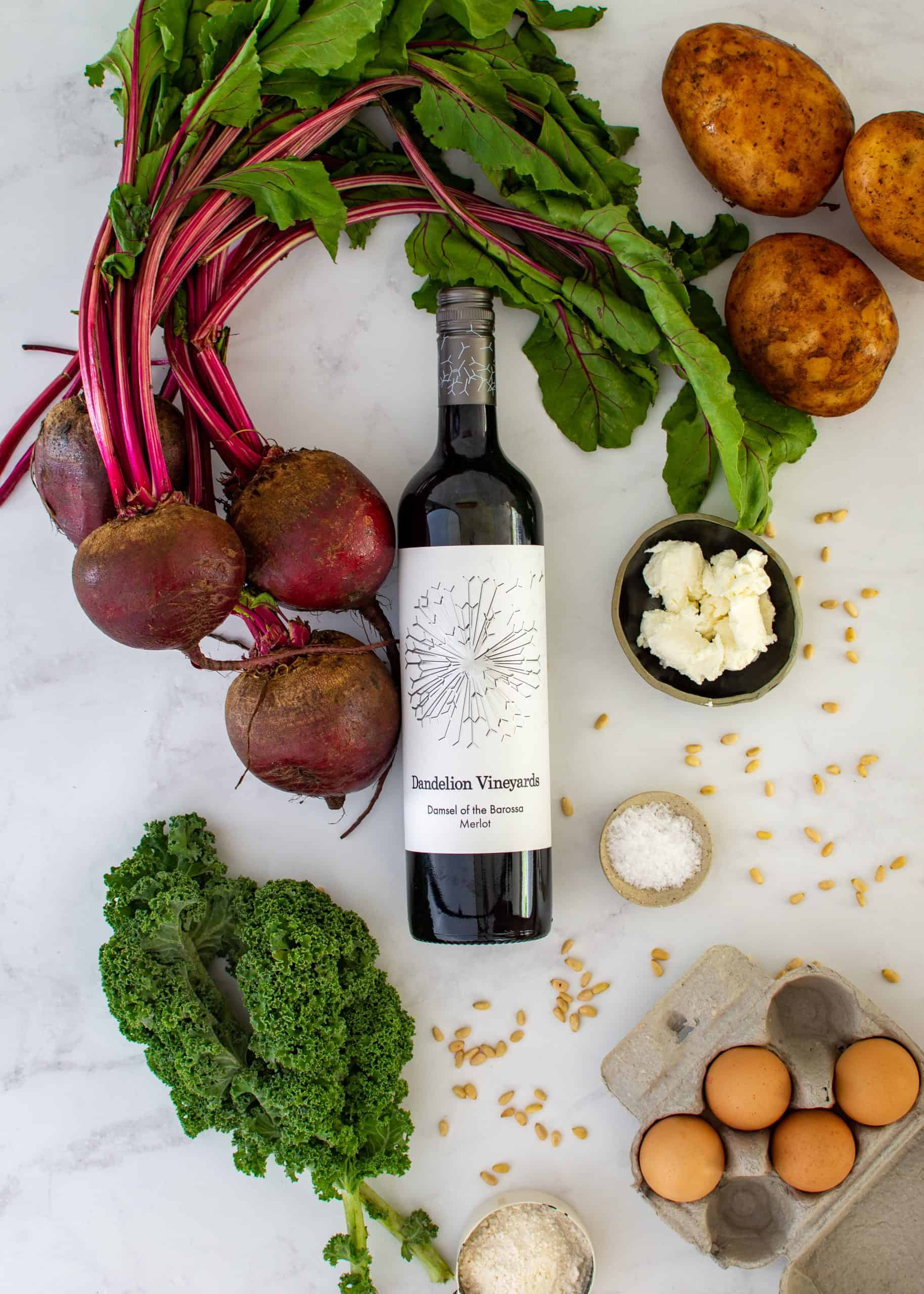 ingredients to make beet gnocchi and a bottle of wine on counter top