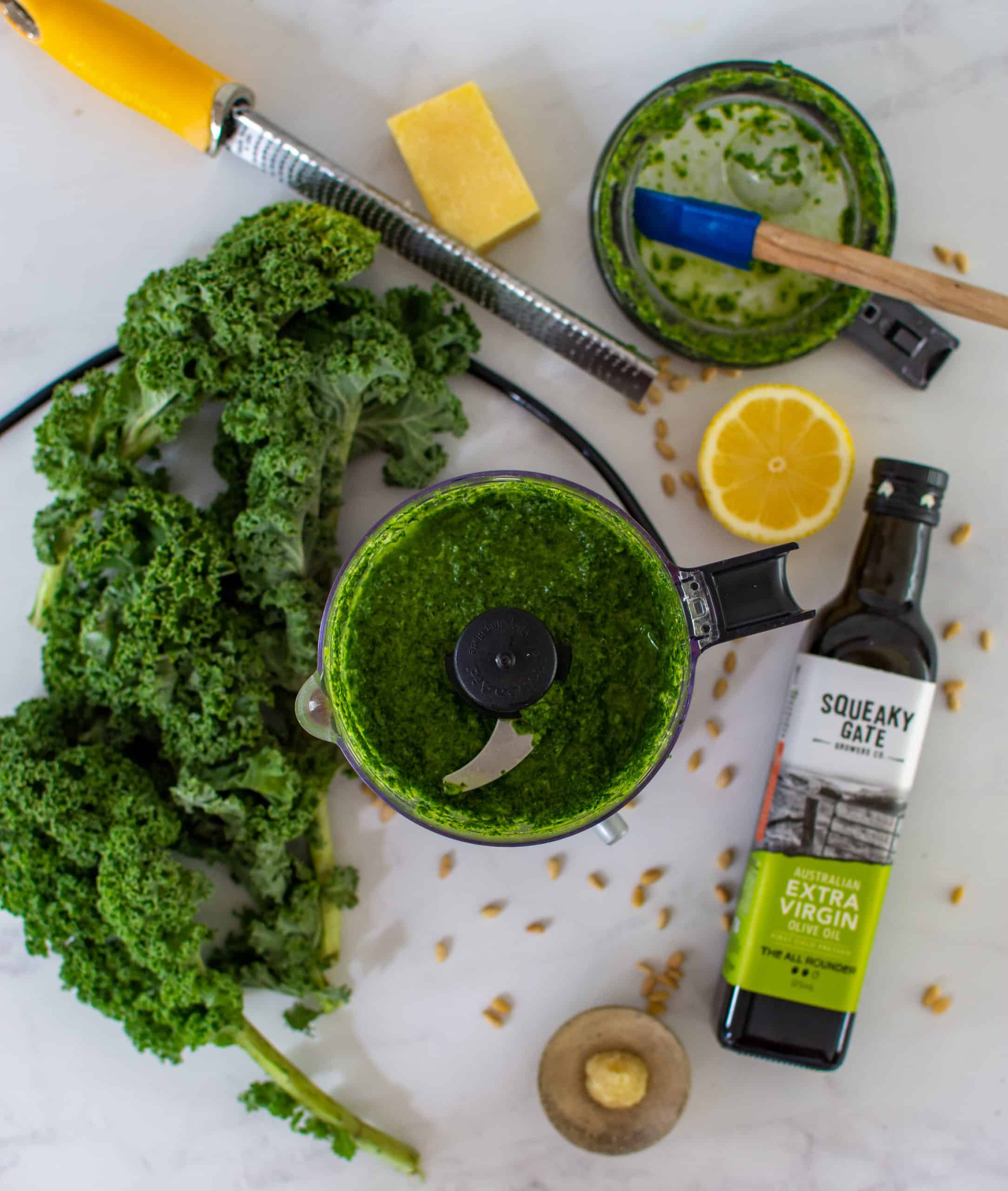 birdseye view of kale pesto in a blender with ingredients