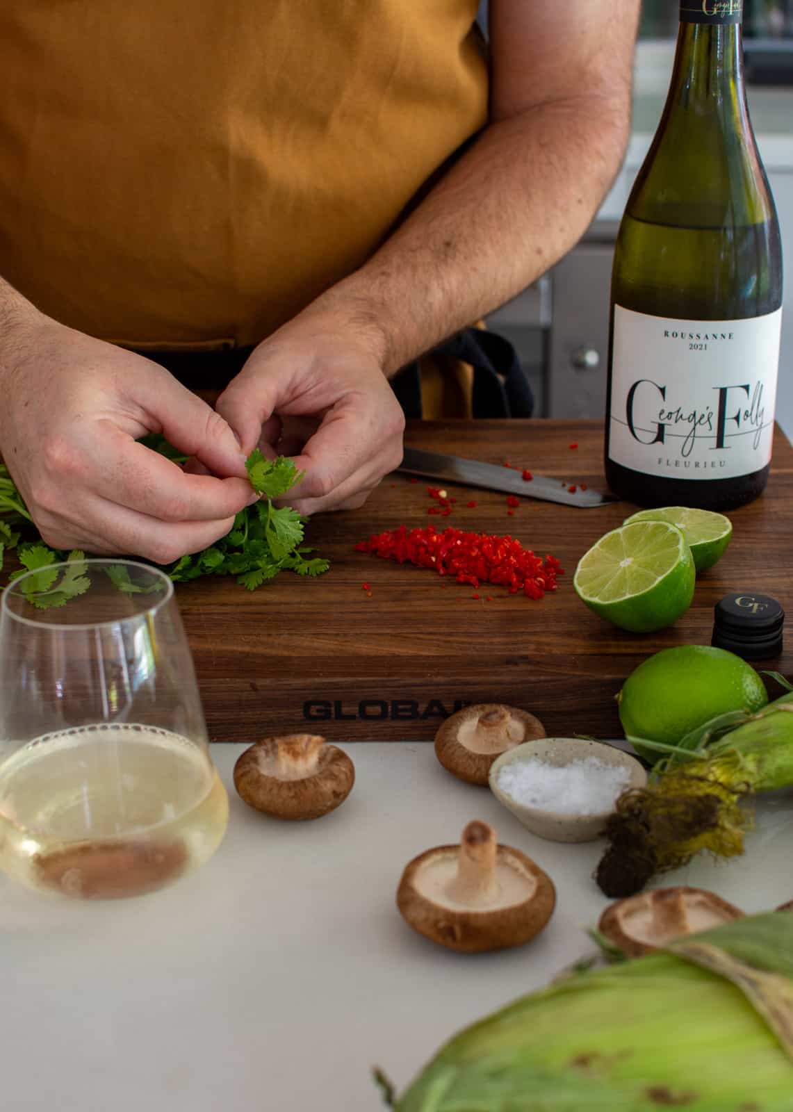 someone picking coriander on a chopping board