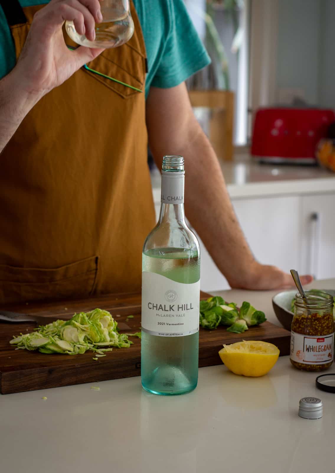 Someone drinking chalk hill vermentino in the kitchen