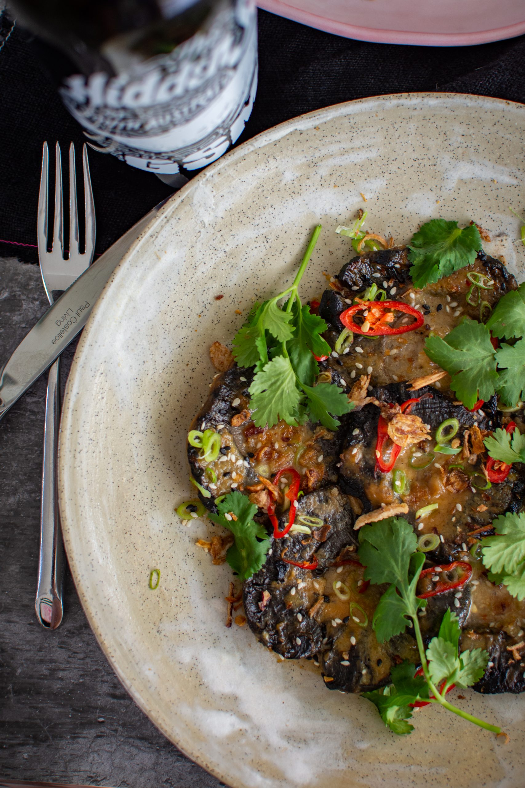 plate of miso mushrooms with hidden sea GSM wine beside the plate