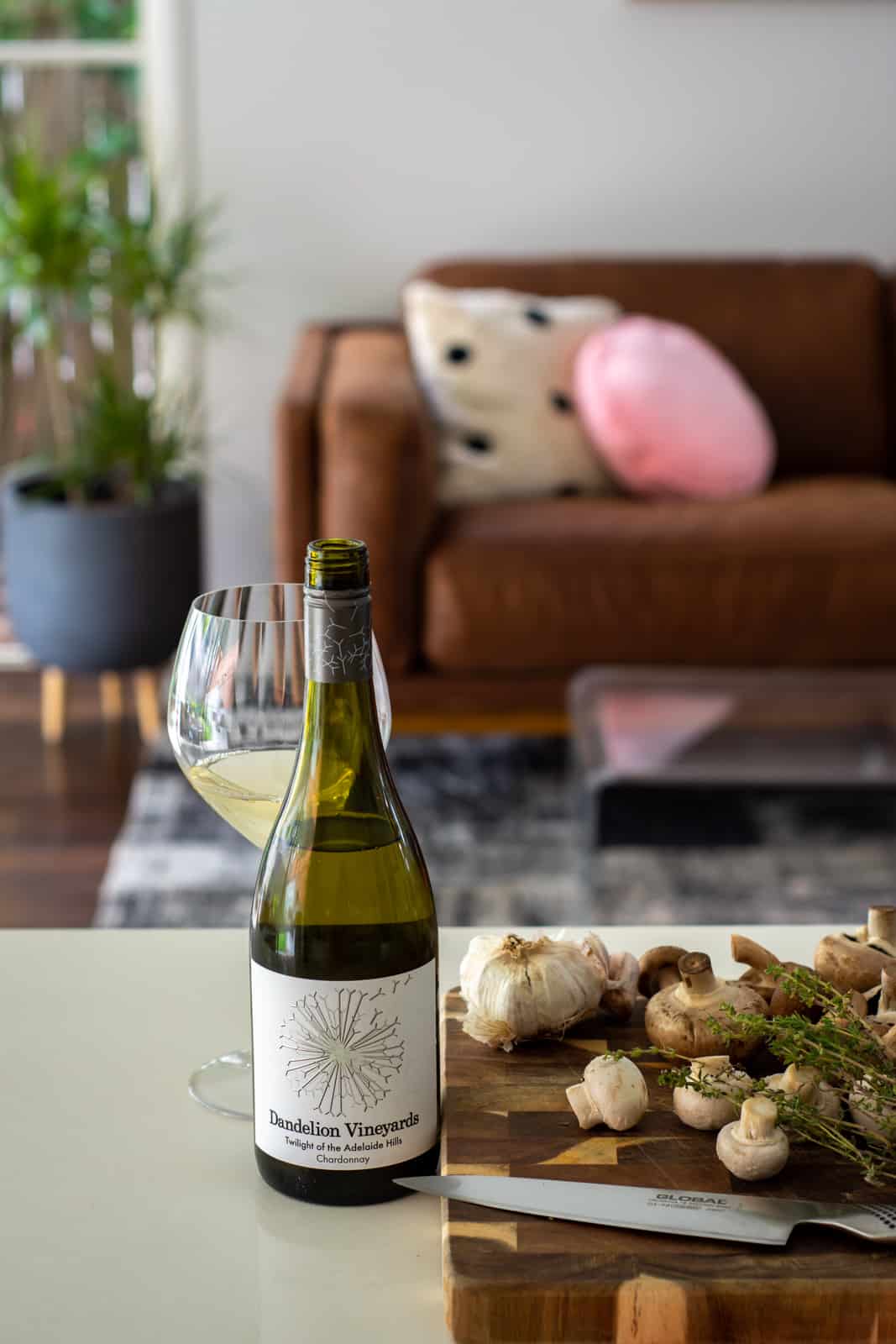 Dandelion vineyards chardonnay on kitchen counter with chopping board of vegetables beside it