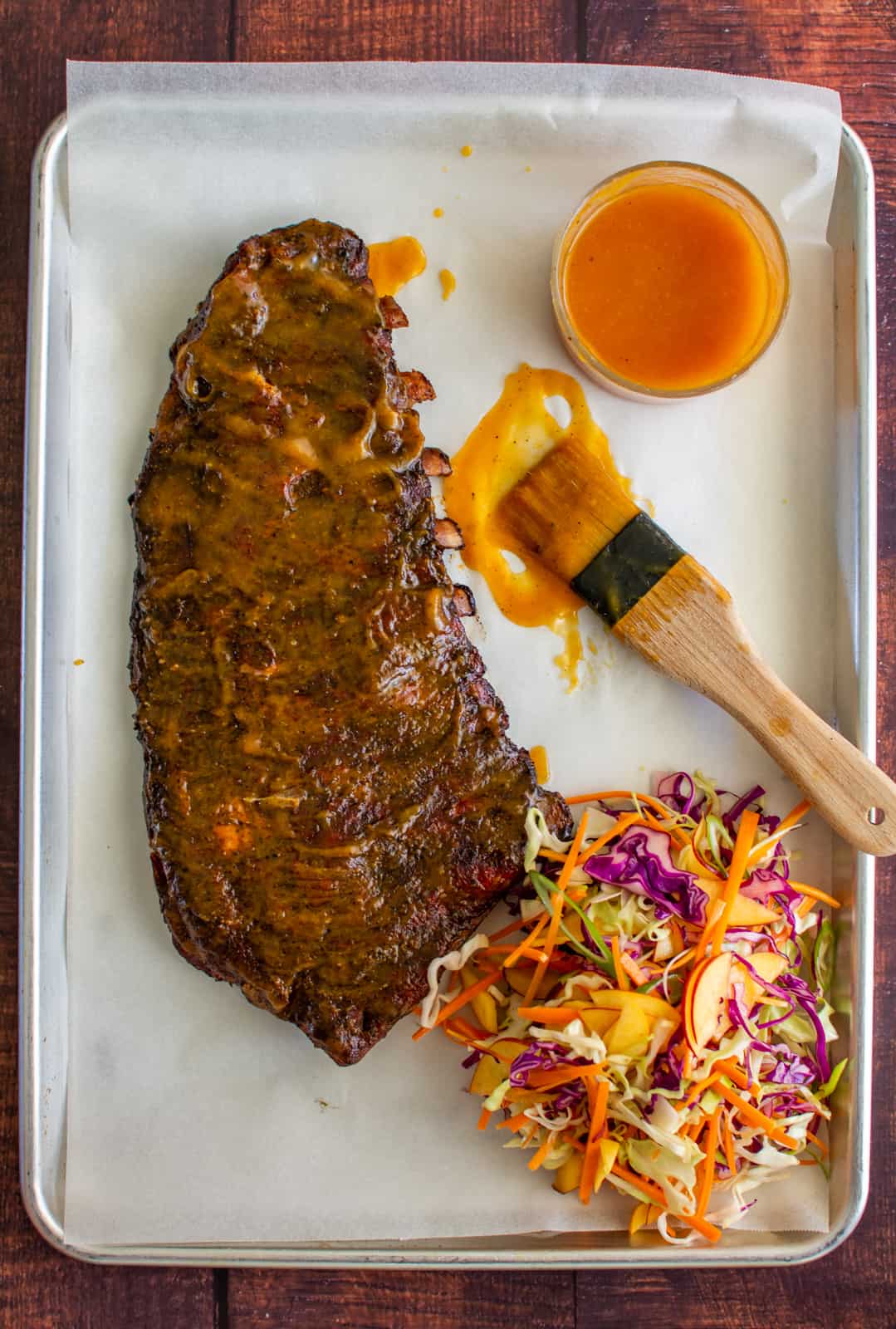 smoked pork ribs with peach sauce and slaw