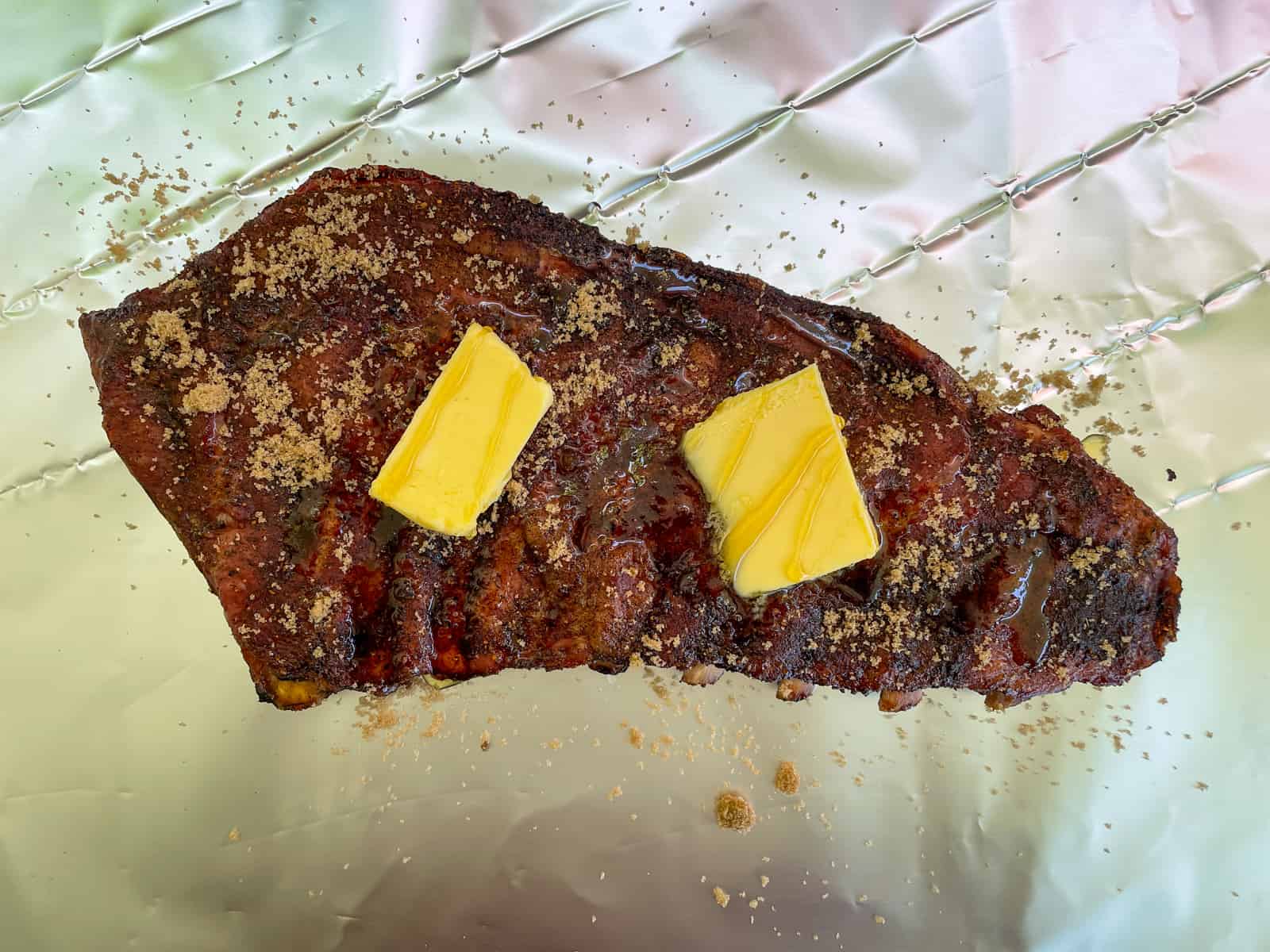 Pork ribs about to be wrapped in foil with honey, butter & sugar