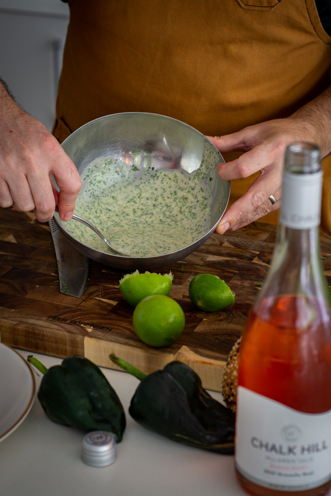 Someone making coriander aioli in the kitchen