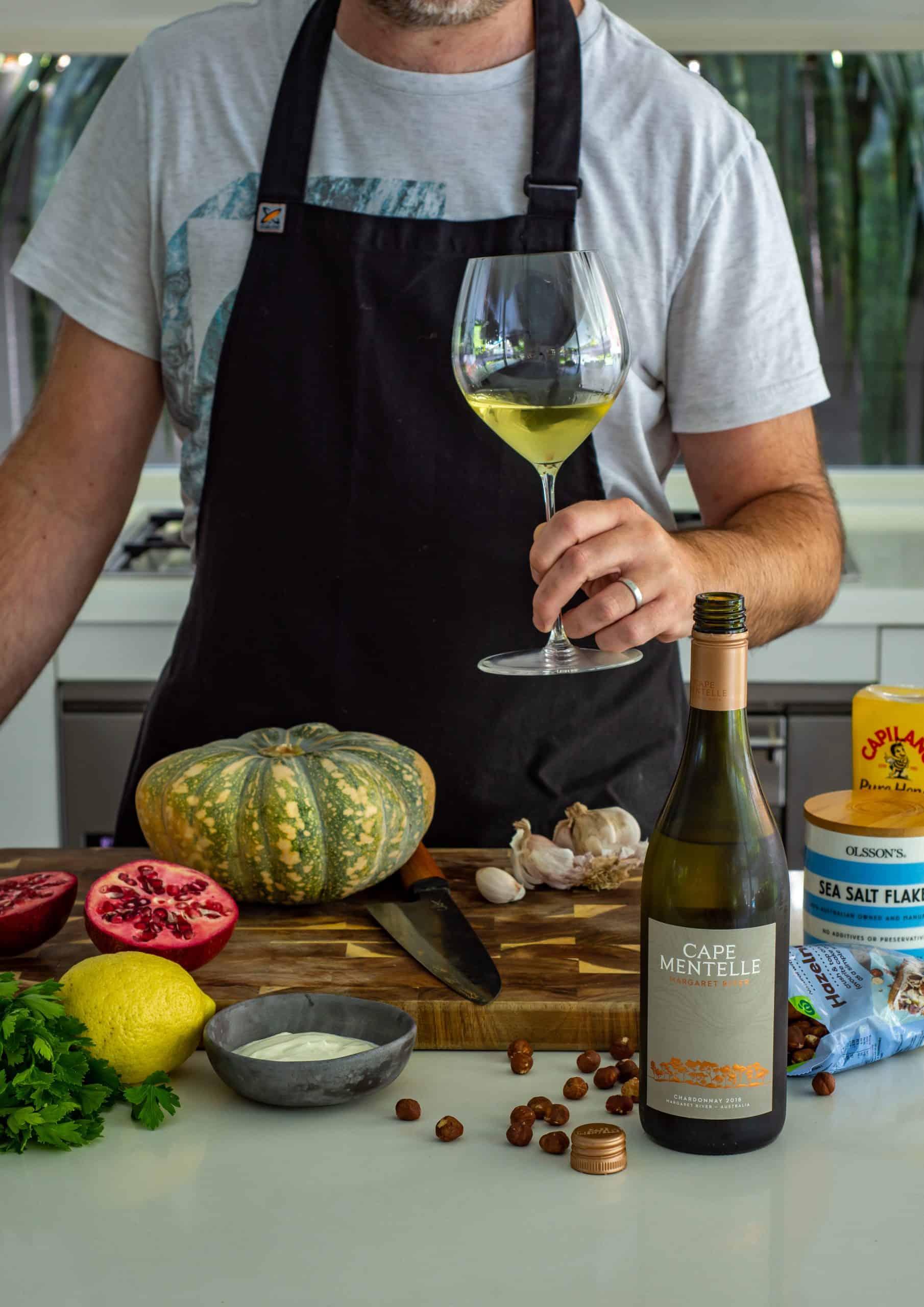 sumac roasted pumpking ingredients in the kitchen with someone drinking a glass of chardonnay