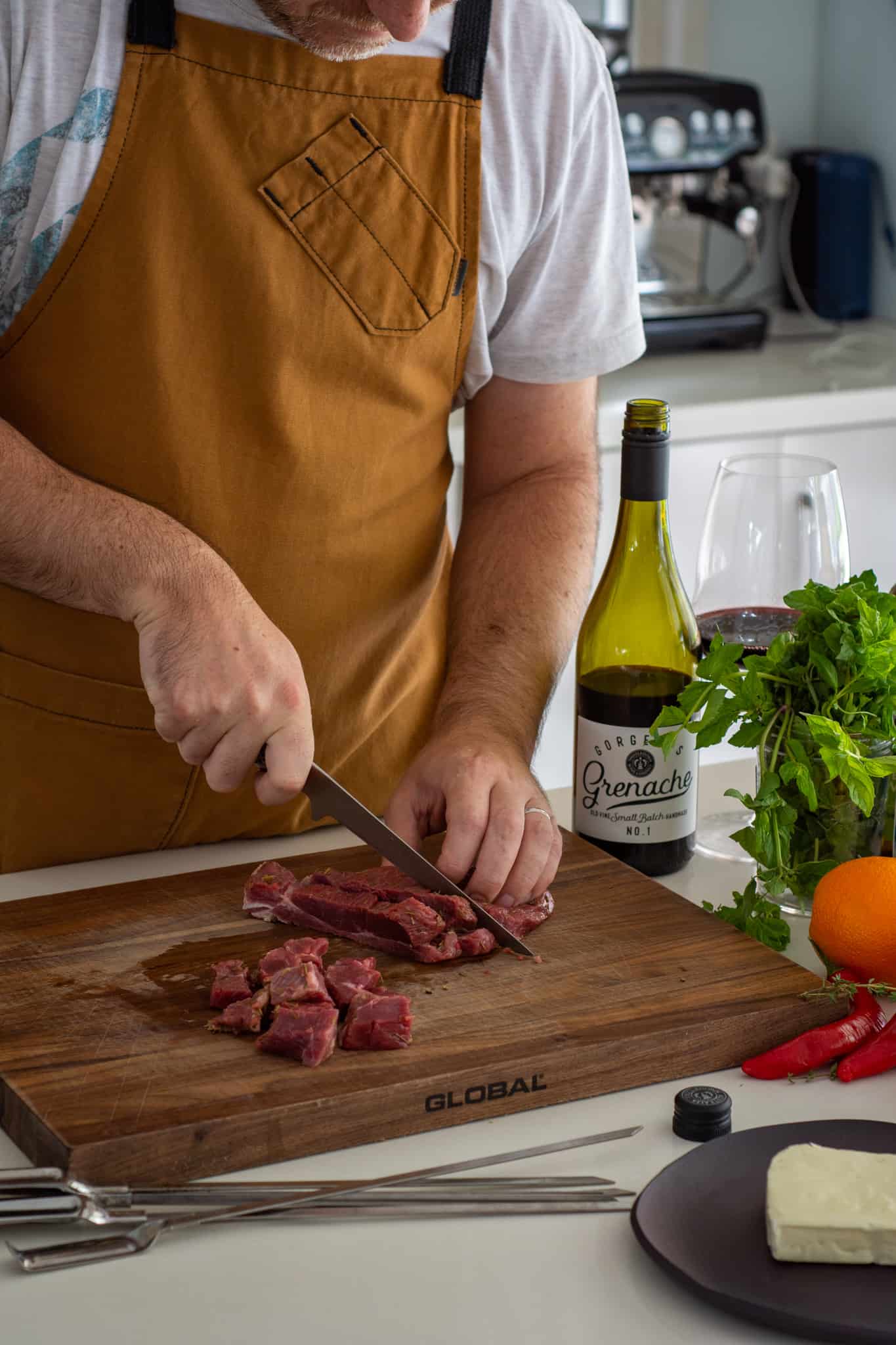 Someone cutting lamb leg in the kitchen