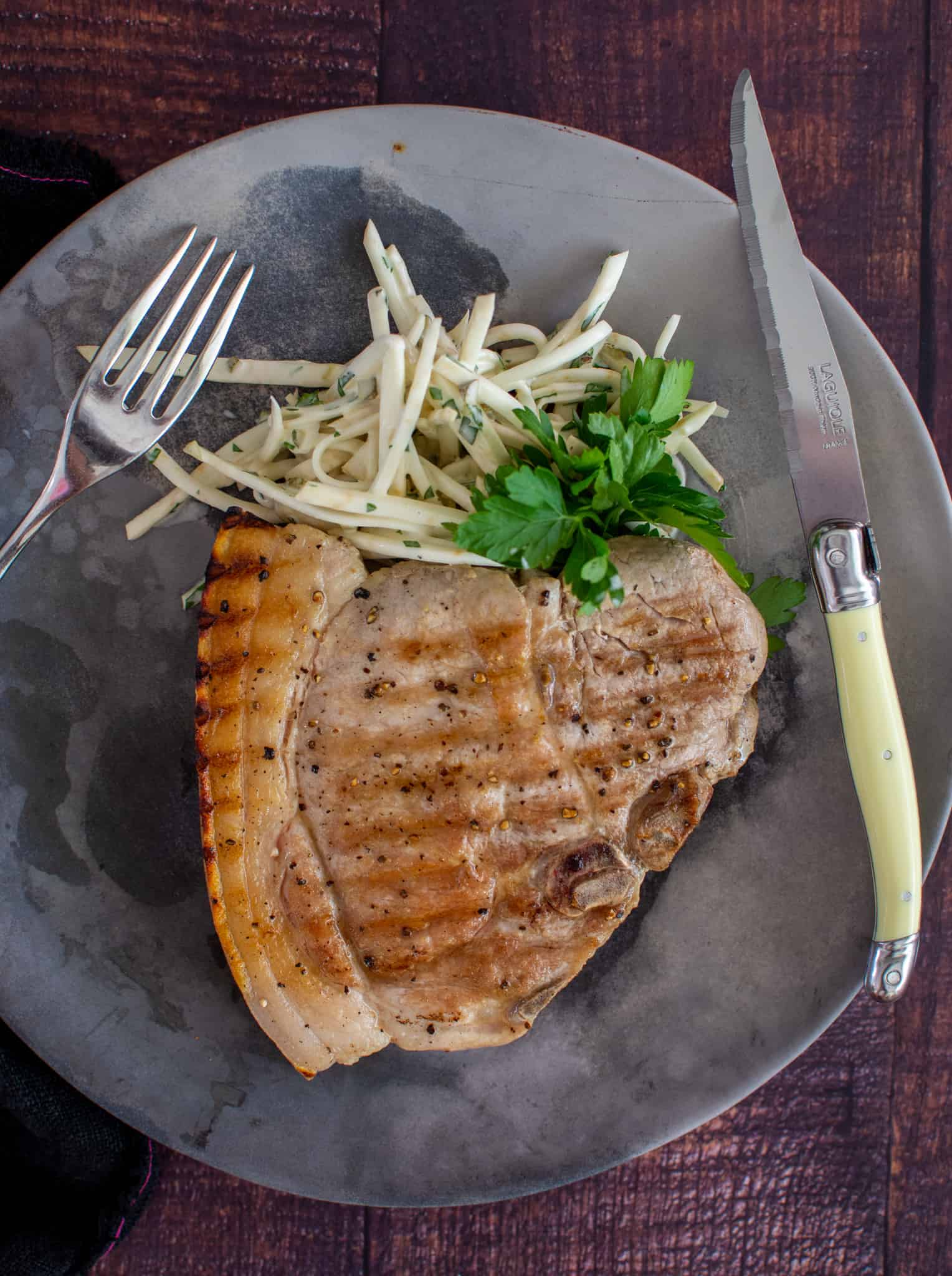 Grilled pork steak and celeriac remoulade on a plate