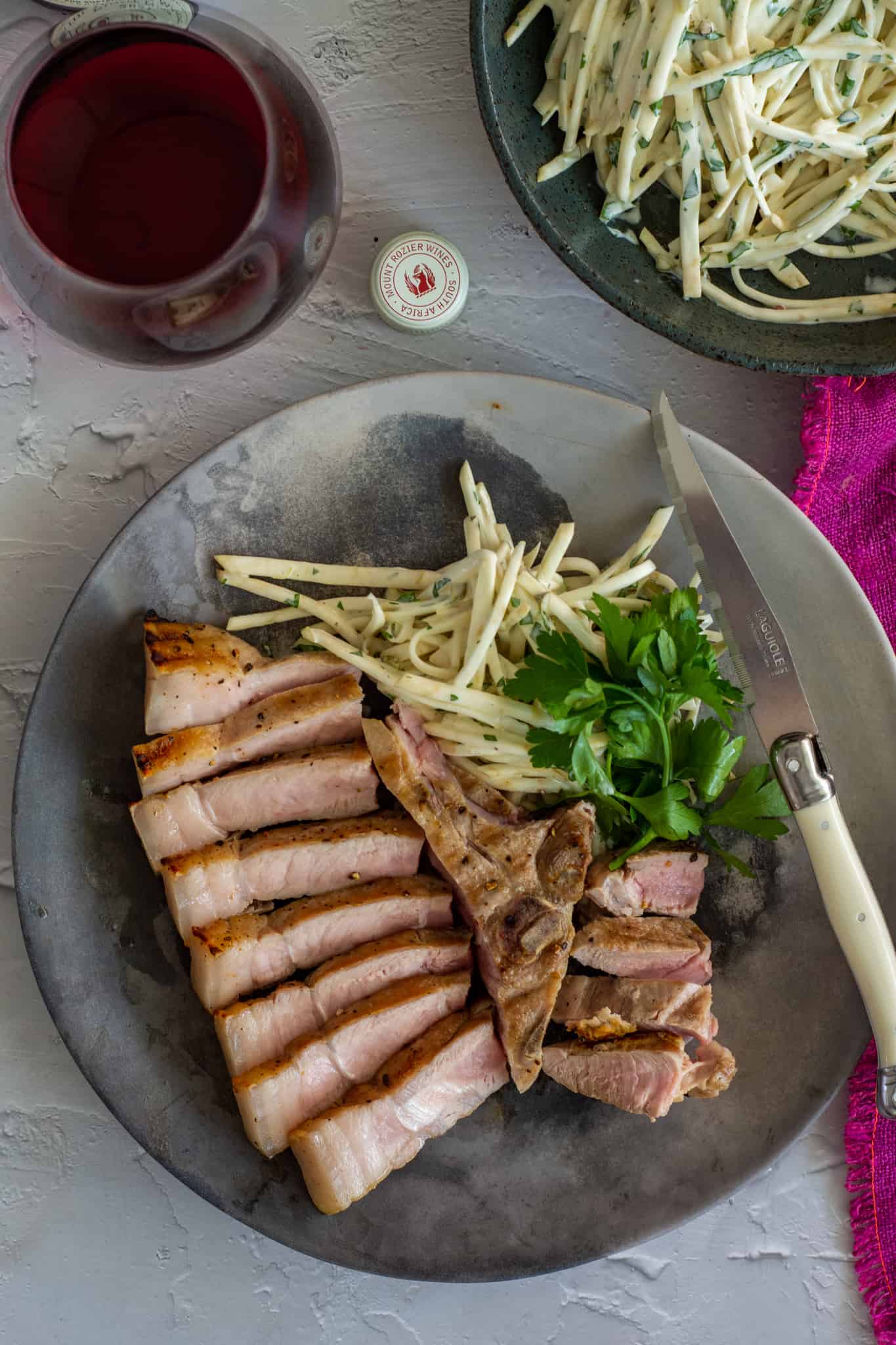 Sliced pork on a plate with celeriac remoulade