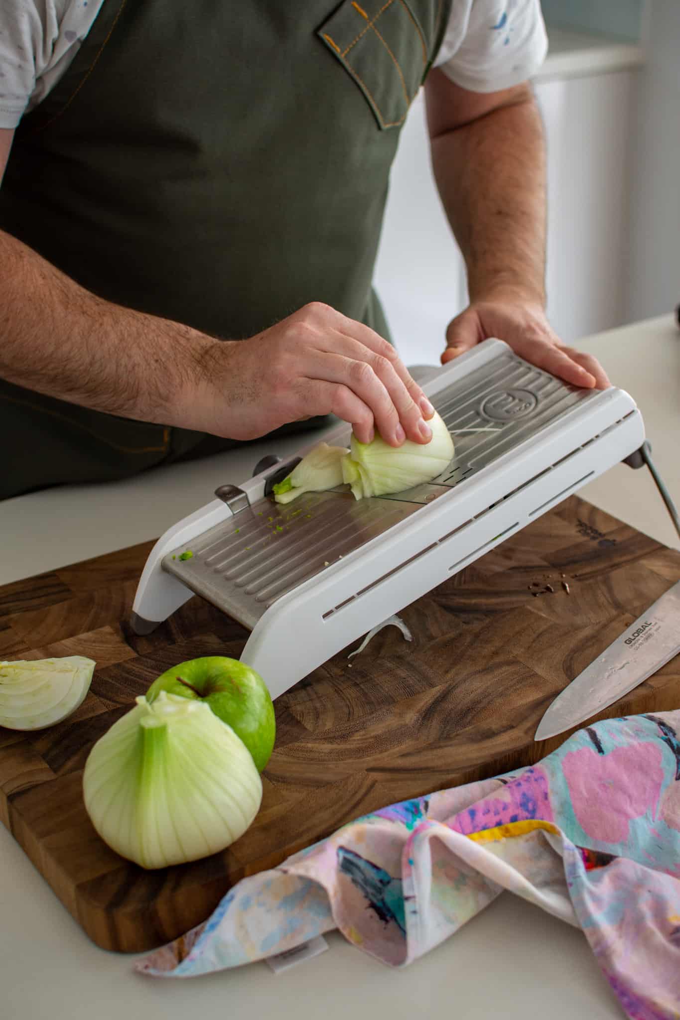 someone slicing fennel in the kitchen