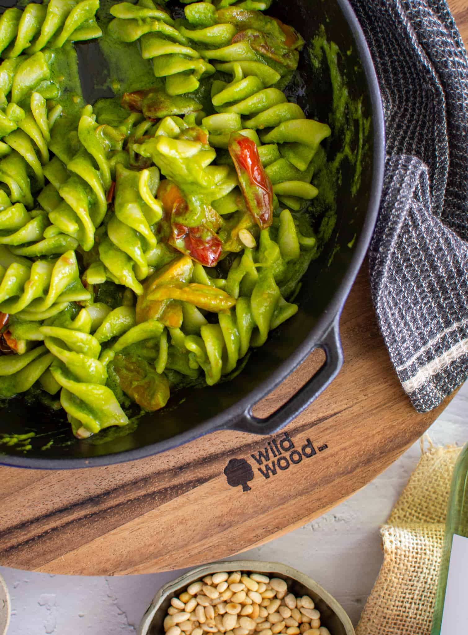 birdseye view of simple avocado pasta in a saucepan on a chopping board
